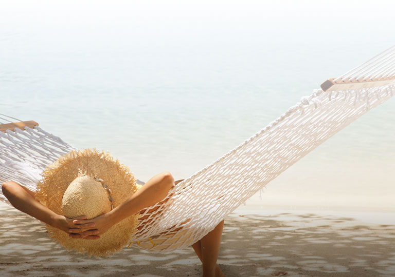 woman lounging under the sun at the beach