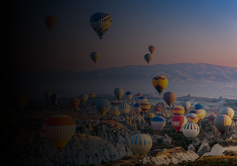 Hot air balloons flying in the sunset